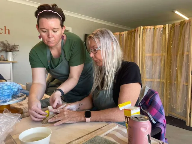 two children doing craft at a table.
