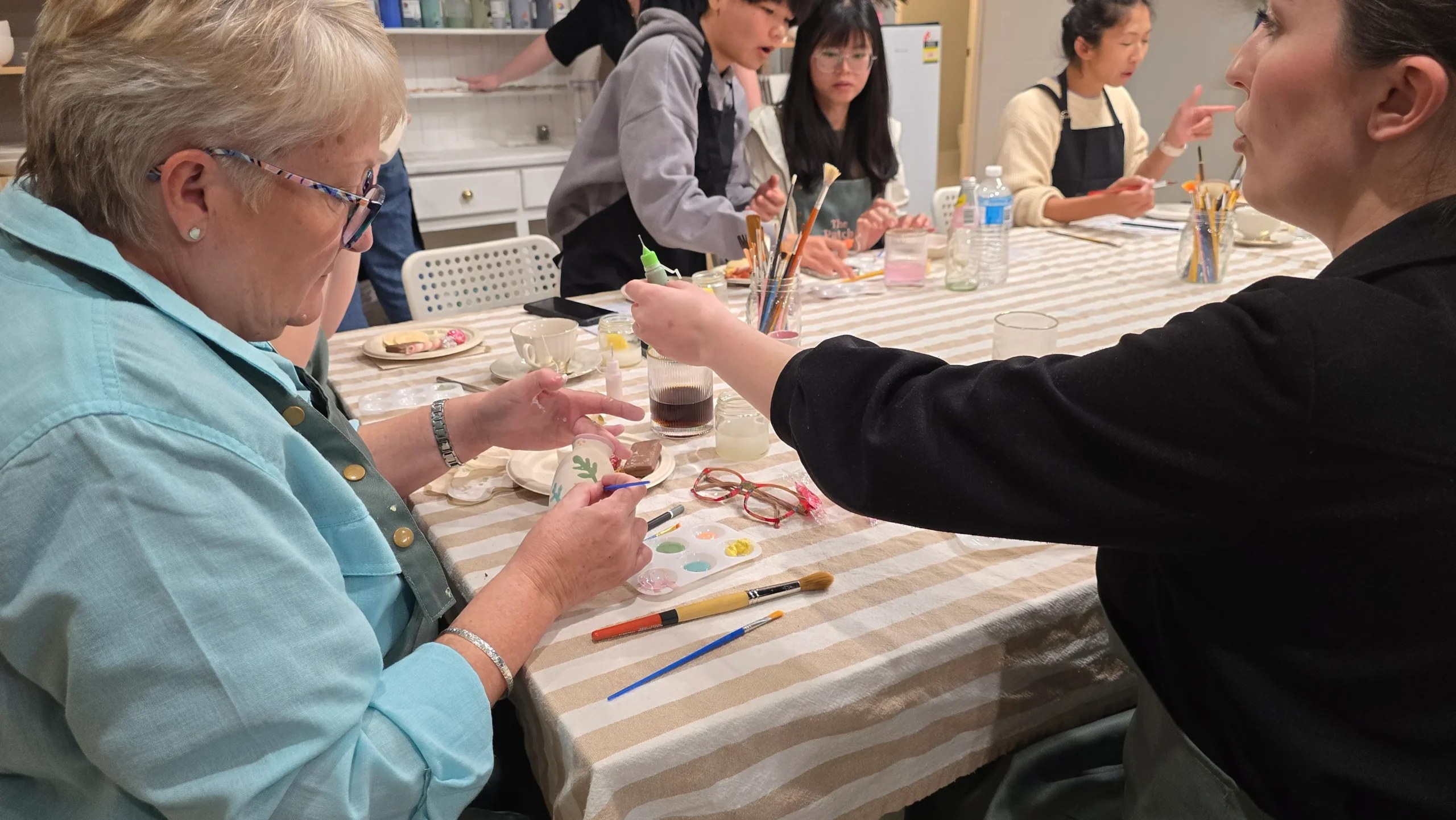 two children doing craft at a table.